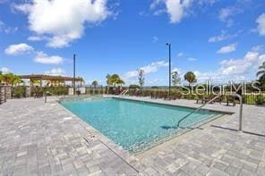 view of swimming pool featuring a patio area