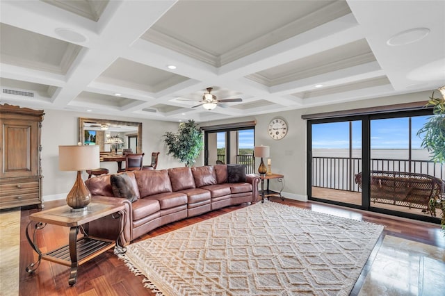 living room with wood-type flooring, beam ceiling, coffered ceiling, ornamental molding, and ceiling fan