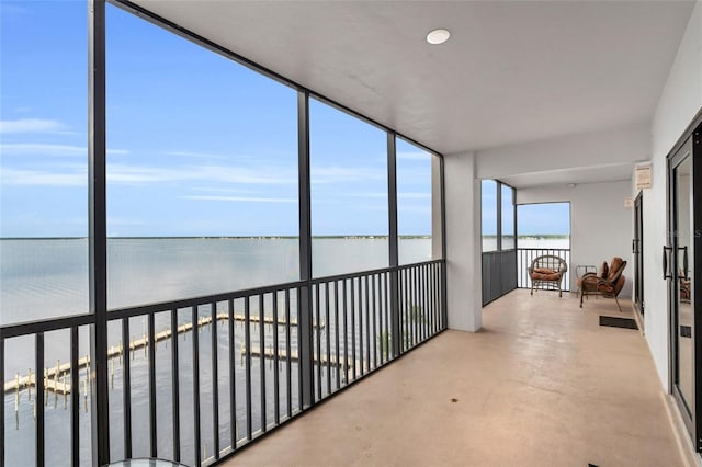 sunroom / solarium with a water view