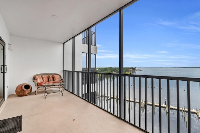 sunroom / solarium with a water view