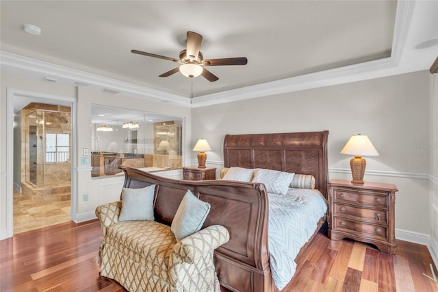 bedroom featuring ceiling fan, ornamental molding, connected bathroom, and dark wood-type flooring