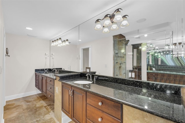 bathroom featuring a shower with door and vanity