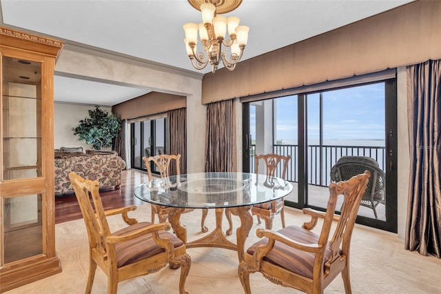 dining room with ornamental molding, a chandelier, and light hardwood / wood-style floors