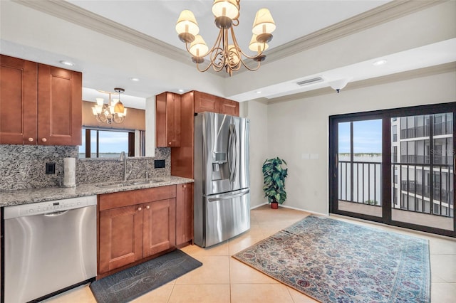 kitchen with stainless steel appliances, a chandelier, plenty of natural light, and sink