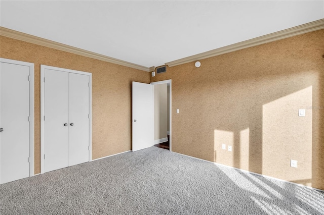 unfurnished bedroom featuring carpet flooring and crown molding