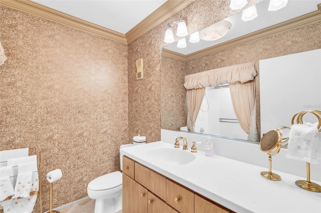 bathroom featuring ornamental molding, vanity, and toilet