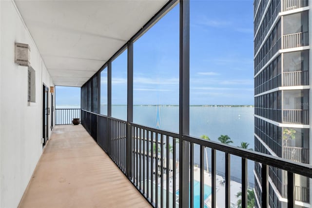 interior space with floor to ceiling windows and a water view