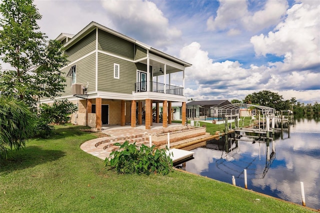 rear view of house with a water view, a patio, stairs, central AC, and a lawn