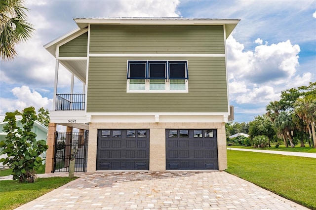 view of front of house with a garage and a front lawn