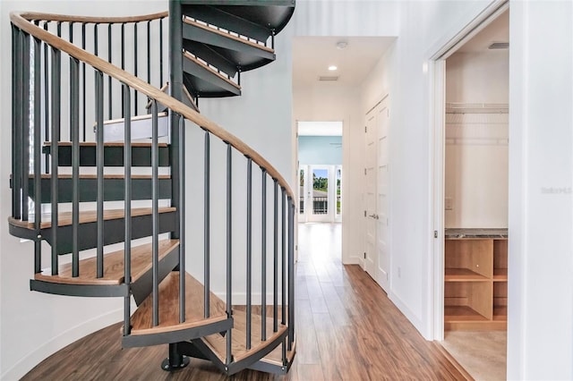 stairway with hardwood / wood-style flooring