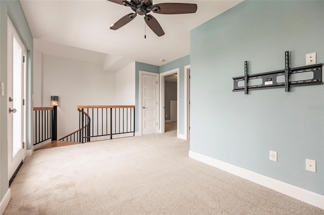 carpeted spare room with ceiling fan