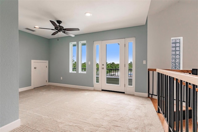 unfurnished room featuring baseboards, visible vents, and light colored carpet