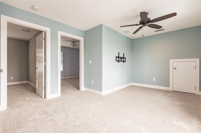 spare room featuring light carpet and ceiling fan