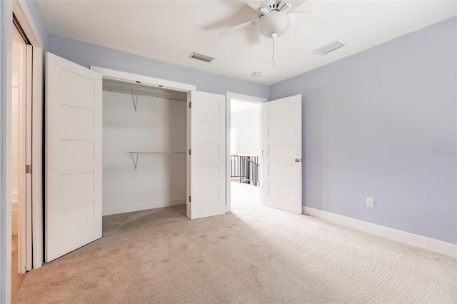 unfurnished bedroom with ceiling fan, a closet, and light carpet