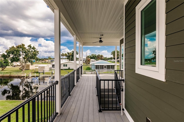 deck featuring a water view and ceiling fan