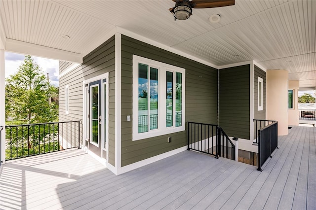 wooden deck featuring ceiling fan