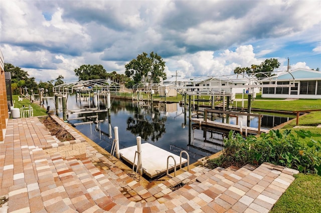 dock area with a water view, boat lift, and a residential view