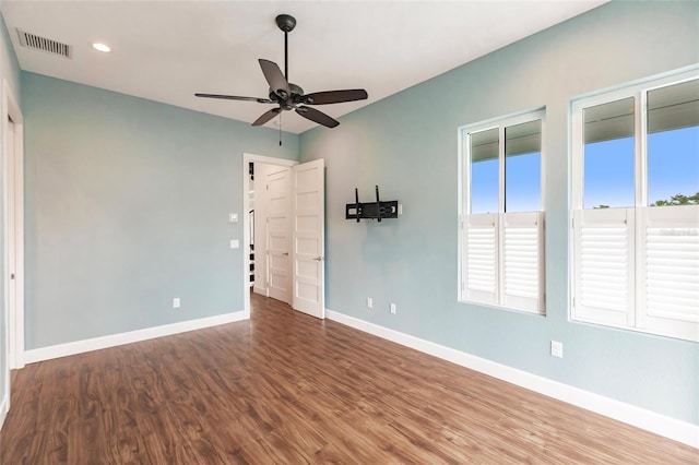 spare room featuring wood-type flooring and ceiling fan