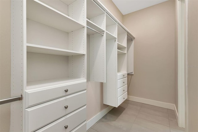 spacious closet featuring light tile patterned floors