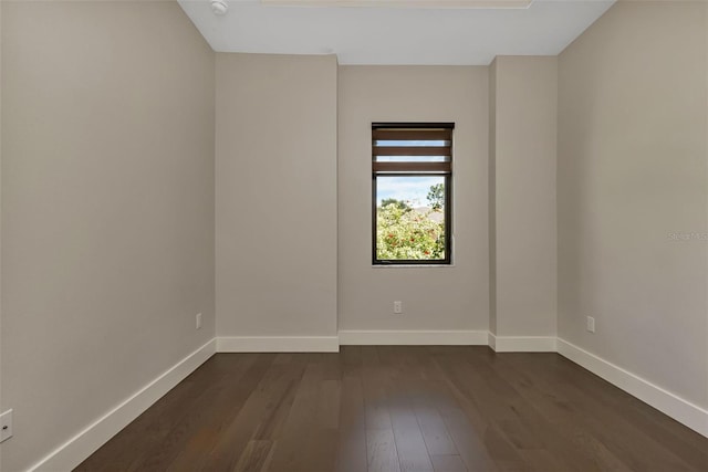 empty room with dark wood-type flooring