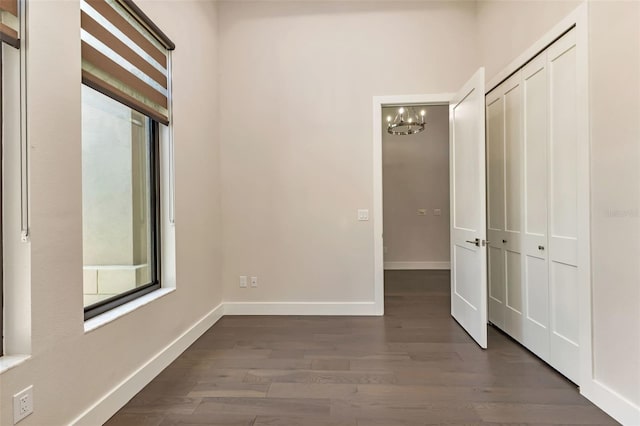 interior space featuring a chandelier and dark hardwood / wood-style flooring