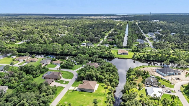 bird's eye view featuring a water view, a wooded view, and a residential view