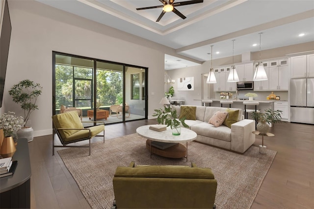 living room with ceiling fan and dark hardwood / wood-style floors