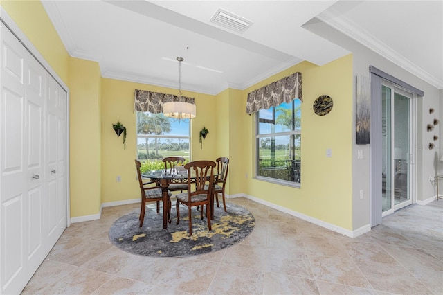 dining area featuring crown molding and a chandelier