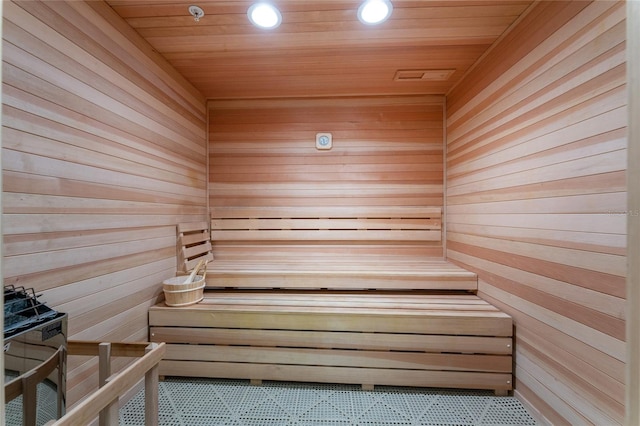 view of sauna with wood ceiling and wooden walls