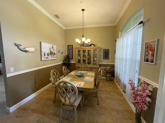 dining area with a chandelier and crown molding