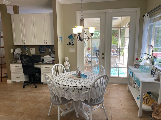 dining area with light tile patterned floors, ornamental molding, and a chandelier