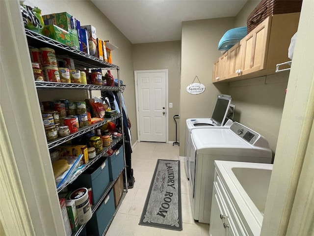 laundry area with cabinets, light tile patterned floors, and washing machine and dryer