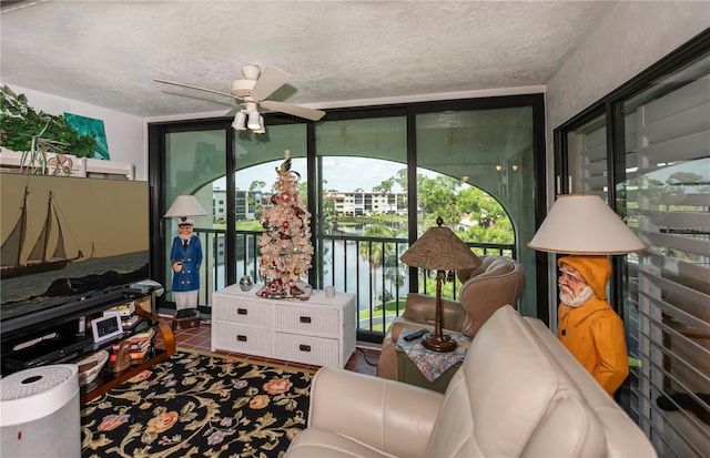 interior space featuring a water view and ceiling fan