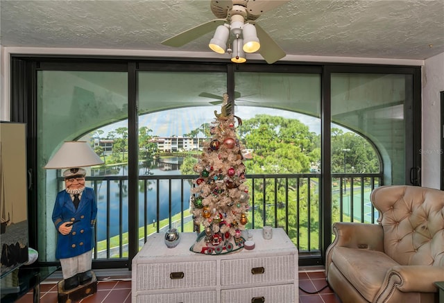 sunroom featuring ceiling fan