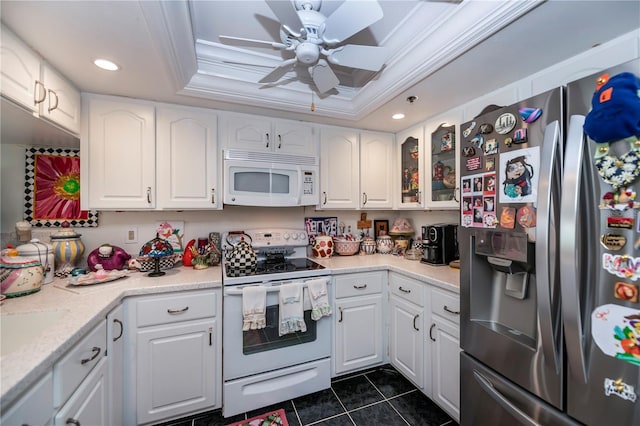 kitchen with white appliances, white cabinetry, and ceiling fan