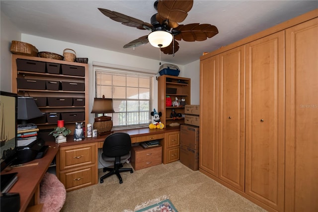 carpeted office featuring ceiling fan