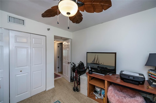 office with ceiling fan and light carpet