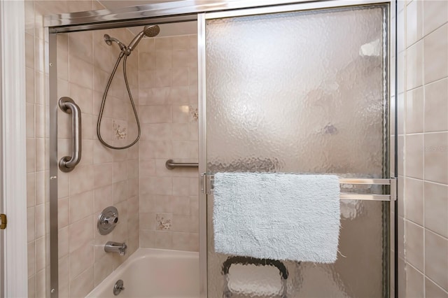 bathroom featuring bath / shower combo with glass door