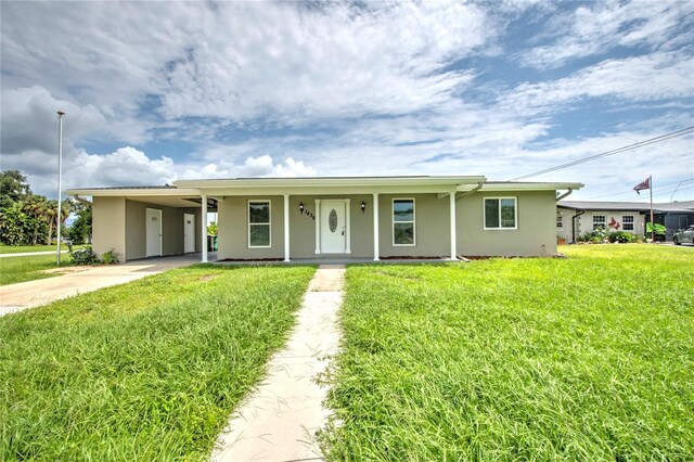 1638 Harmony Dr, Port Charlotte, FL 33952 - ranch-style home featuring an attached carport, stucco siding, a front yard, and concrete driveway