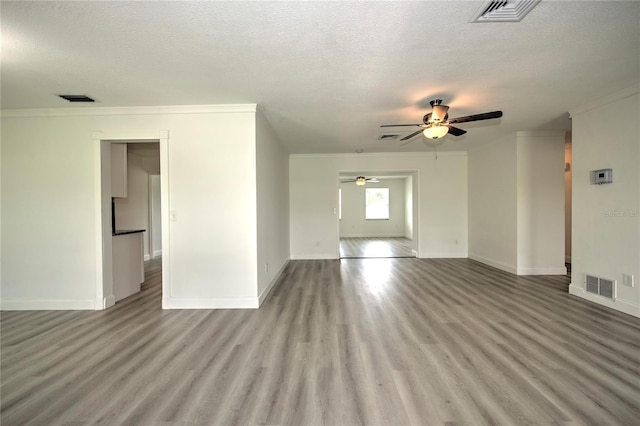 1638 Harmony Dr, Port Charlotte, FL 33952 - unfurnished living room featuring visible vents, a ceiling fan, and wood finished floors