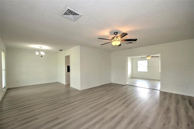 unfurnished room with hardwood / wood-style flooring, ceiling fan with notable chandelier, ornamental molding, and a textured ceiling