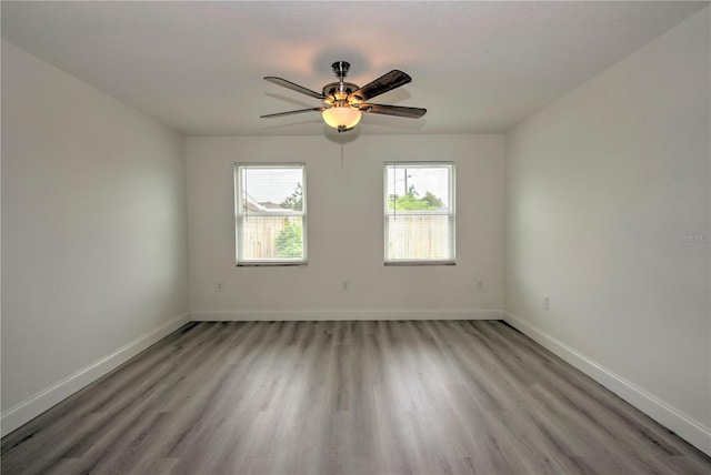 spare room featuring light hardwood / wood-style flooring and ceiling fan