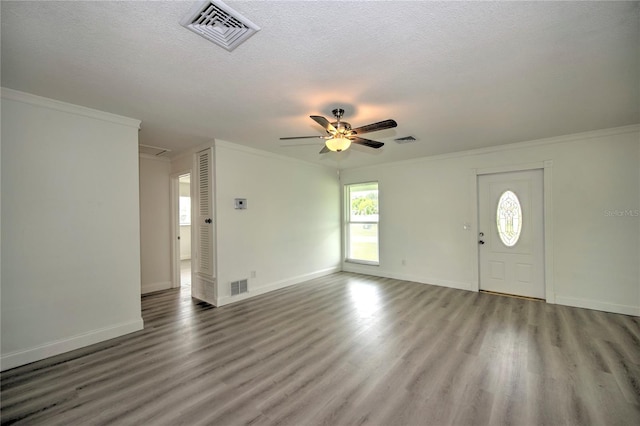 1638 Harmony Dr, Port Charlotte, FL 33952 - entrance foyer with wood finished floors, a textured ceiling, and visible vents