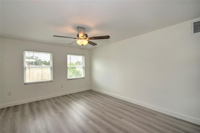 unfurnished room with ceiling fan and light wood-type flooring