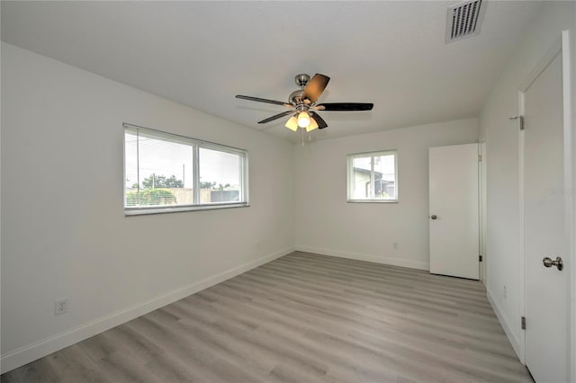 empty room with light wood-type flooring and ceiling fan