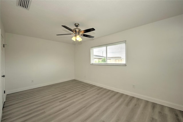 spare room featuring ceiling fan and light hardwood / wood-style floors