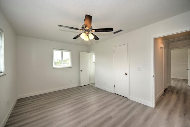 unfurnished bedroom with light hardwood / wood-style floors and ceiling fan