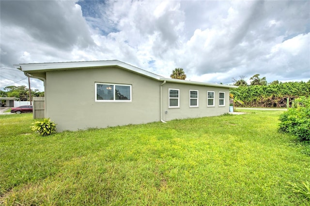 1638 Harmony Dr, Port Charlotte, FL 33952 - back of property featuring stucco siding and a yard