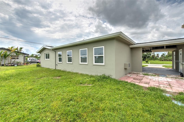 back of house with a yard and a wall unit AC