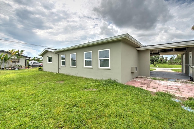 1638 Harmony Dr, Port Charlotte, FL 33952 - back of property featuring stucco siding, an AC wall unit, and a yard